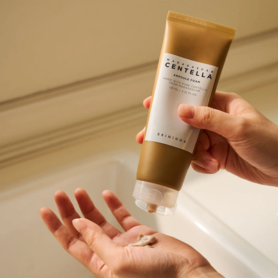 SKIN1004 Madagascar Centella Ampoule Foam 125ml — hands holding tube